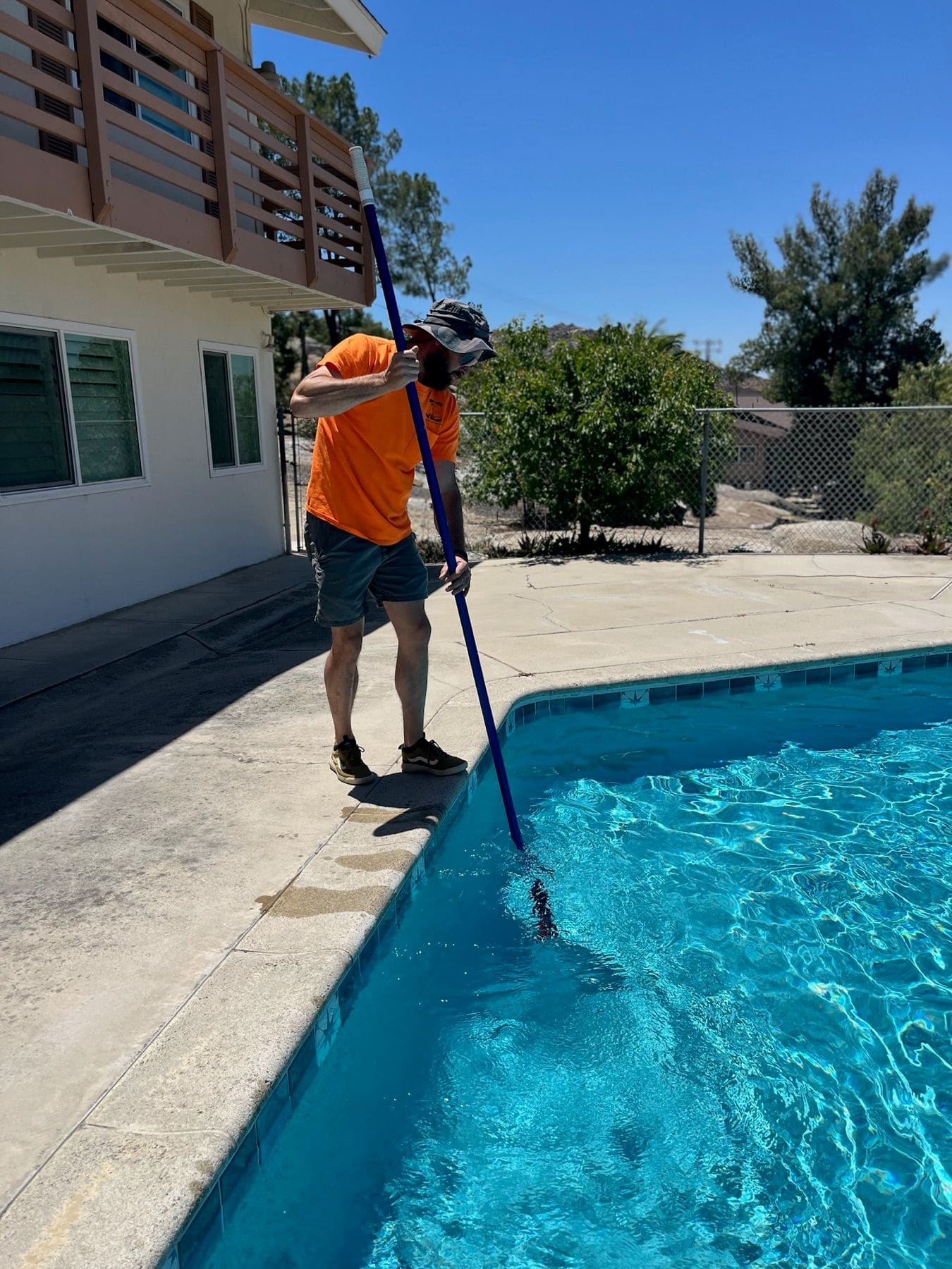 Grady brushing pool walls and steps